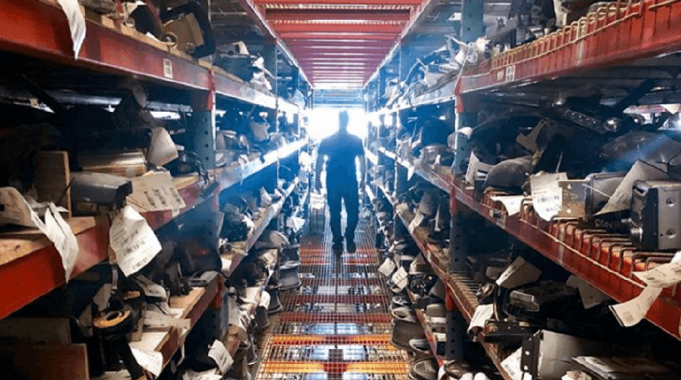 man walking down aisle of car parts